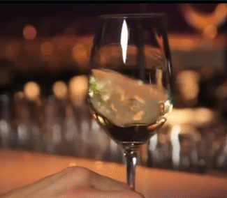 Swirling wine in stemmed glass