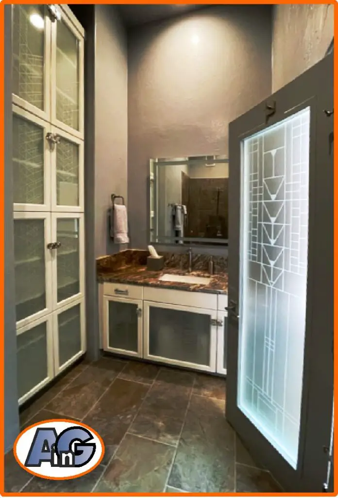 Bathroom with etched glass cabinets and door